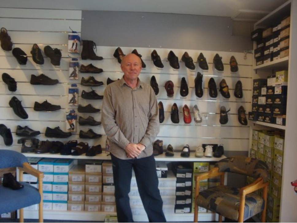 Photo of Comfoot Footwear owner standing in the store front.